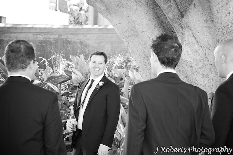 Groom laughing back at his groomsmen - wedding photography sydney